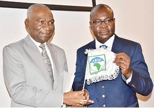 Charles Booto a Ngon (left), outgoing President of the African Organisation for Standardisation, handing over to Professor Alex Dodoo, the newly sworn-in President of ARSO